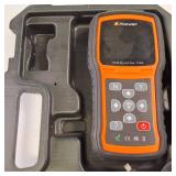 The Foxwell T1000 diagnostic tool used to activate, decode and program tire pressure (TPMS) sensor
