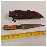 Fixed-blade knife with a distinctive Damascus steel blade - nice leather sheath