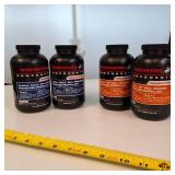 Lot of 4 1-pound containers of Winchester smokeless rifle powder, ideal for high-performance reloading.
