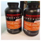 Lot of 4 1-pound containers of Winchester smokeless rifle powder, ideal for high-performance reloading.