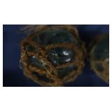 4 SMALL JAPENESE GLASS FISHING FLOATS, WITH 4 BOTTLES OF FIRE BRINE