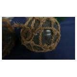 4 SMALL JAPENESE GLASS FISHING FLOATS, WITH 4 BOTTLES OF FIRE BRINE