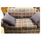 Plaid loveseat upholstered in navy, red, and green fabric. Approx. 57 Inch Long