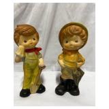 Pair of vintage ceramic piggy bank figurines, often referred to as "Hummel-like" or "Homco" style