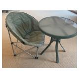 Green Folding Chair with Cushioned Seat & Round Glass Table
