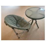 Green Folding Chair with Cushioned Seat & Round Glass Table
