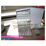 Machinist measuring and cutting too...