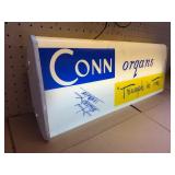 This vintage sign features branding for Conn organs, a prominent manufacturer of electronic organs