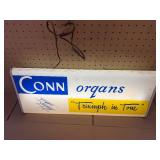This vintage sign features branding for Conn organs, a prominent manufacturer of electronic organs