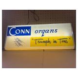 This vintage sign features branding for Conn organs, a prominent manufacturer of electronic organs