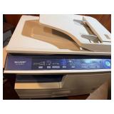 Sharp AL-2040CS desktop digital copier/printer powers on makes copies.
