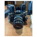 classic Canon AE-1 35mm film photography kit with several compatible accessories
