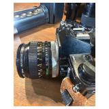 classic Canon AE-1 35mm film photography kit with several compatible accessories