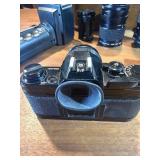 classic Canon AE-1 35mm film photography kit with several compatible accessories