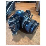 classic Canon AE-1 35mm film photography kit with several compatible accessories