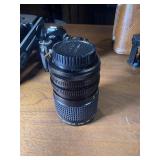 classic Canon AE-1 35mm film photography kit with several compatible accessories