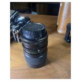 classic Canon AE-1 35mm film photography kit with several compatible accessories