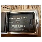 This item is a vintage Polaroid Land Camera, specifically identified as a Model 80 Highlander from the 1950s
