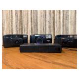 Vintage film cameras, including models from Vivitar, Nikon, and Canon.