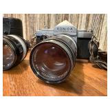 vintage Konica 35mm SLR film camera with multiple lenses