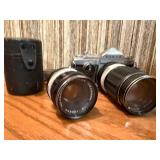 vintage Konica 35mm SLR film camera with multiple lenses