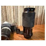 vintage Konica 35mm SLR film camera with multiple lenses