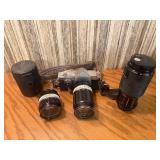 vintage Konica 35mm SLR film camera with multiple lenses