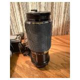 vintage Konica 35mm SLR film camera with multiple lenses