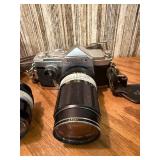 vintage Konica 35mm SLR film camera with multiple lenses