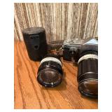 vintage Konica 35mm SLR film camera with multiple lenses