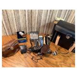 The image displays a collection of vintage cameras and photography accessories, look close at these gems !