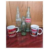 3 Coke Bottles, 2 Coke Mugs "George"