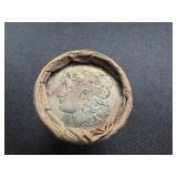 Unopened 20 coin roll of Morgan silver dollars with a high grade 1893 at one end and a high grade CC at the other end