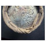 Unopened 20 coin roll of Morgan silver dollars with a high grade 1893 at one end and a high grade CC at the other end