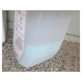 Full and partial jugs of ice melt...