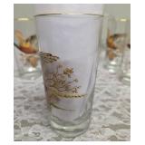 Pitcher with 5 glasses.  These items are likely produced by the "West Virginia Glass" likely from the mid-century era, featuring a distinctive pheasant-in-flight design with gold rim embellishments.