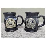Two handmade stoneware mugs commonly sold as souvenirs at Renaissance Festivals.  Produced by Deneen Pottery.