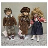 Three collectible porcelain dolls.  From the Premier Doll collection.
