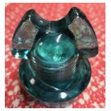 Mickey Mouse glass insulator specifically a CD 257 type manufactured by Hemingray. Were used on power poles to insulate telegraph and telephone wires from the wooden poles holding them.
