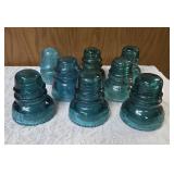 Eight Vintage electric line insulators most likely produced by the Hemingray Glass Company.  Aqua-blue color is characteristic of early 20th century glass manufacturing.