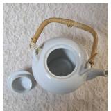 Mikasa fine China white teapot with a lid made of  porcelain with woven bamboo handle.   Mikasa origin is Japan.