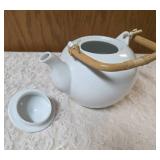 Mikasa fine China white teapot with a lid made of  porcelain with woven bamboo handle.   Mikasa origin is Japan.
