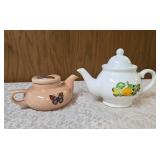 VINTAGE-Two ceramic teapots one with flowers and the other butterflies.