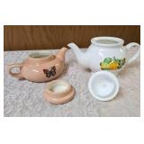 VINTAGE-Two ceramic teapots one with flowers and the other butterflies.