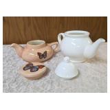 VINTAGE-Two ceramic teapots one with flowers and the other butterflies.