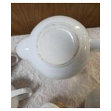 Vintage porcelain tea set featuring a teapot with a rattan handle, a creamer, and a sugar bowl, similar in style to Japanese or German postmodern designs from the mid-to-late 20th century.