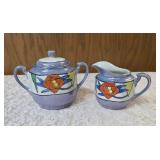 Vintage Art Deco Japanese Lusterware creamer and sugar bowl set.  Features a hand-painted iridescent glaze with a stylized abstract floral or geometric pattern.  Produced in Japan likely between 1921-