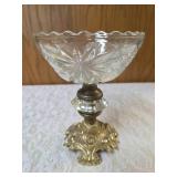 Vintage Hollywood Regency style centerpiece compote , featuring a cut or etched crystal glass bowl set upon an ornate brass pedestal base. Dimensions 8" t x 6"d.