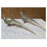Two vintage brass pheasant figurines. Figurines are solid brass with a polished or natural patina finish and are considered mid-century modern, featuring etched feather detailing.  Approx. 15" long.  