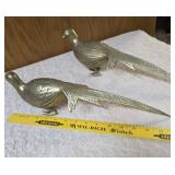 Two vintage brass pheasant figurines. Figurines are solid brass with a polished or natural patina finish and are considered mid-century modern, featuring etched feather detailing.  Approx. 15" long.  